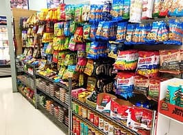 Snack aisle with chips, candy, and packaged goods.