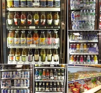 Refrigerator wall with bottled juices, sodas, and kombucha.